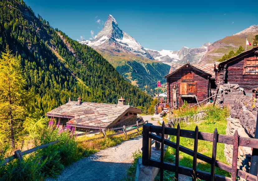 Sunny summer morning in Zermatt village with Matterhorn (Monte Cervino, Mont Cervin) peak on backgroud.